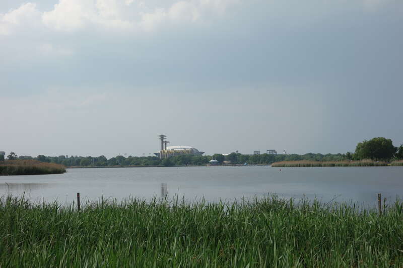 Looking at Meadow Lake from a newly-constructed footbridge in the Meadow Lake section of Flushing Meadows–Corona Park, on Meadow Lake Drive near Jewel Avenue / 69th Road between Forest Hills and Queensboro Hill, Queens. In the distance is the former