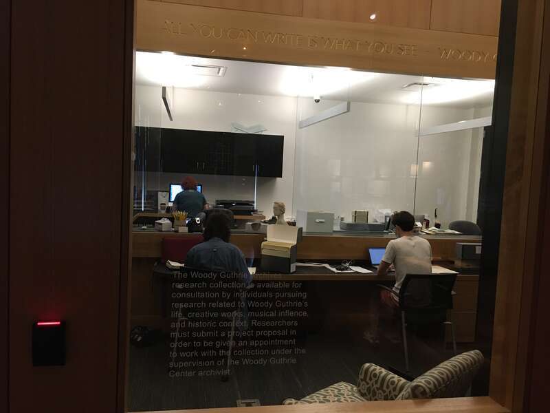Researchers at work in the Woody Guthrie Center Archives in Tulsa, Oklahoma.  The inscription on the door describes the requirements to be able to access the archives.
