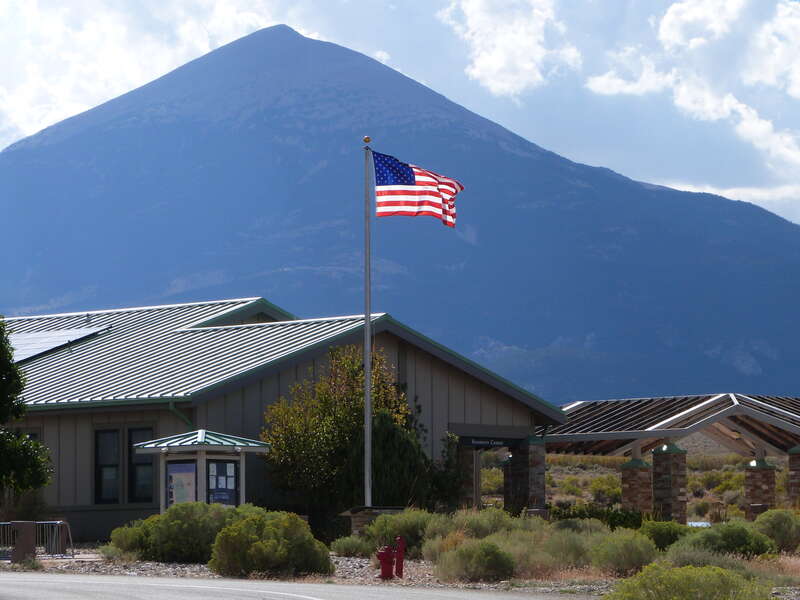 The Great Basin Visitor Center and park headquarters of Great Basin National Park with backlit flag, Baker, Nevada, United States.