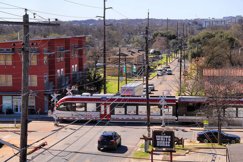 Looking south at the 400 and 300 block (in that order) of Comal Street in Austin, Texas, United States with Capital MetroRail running across Comal.