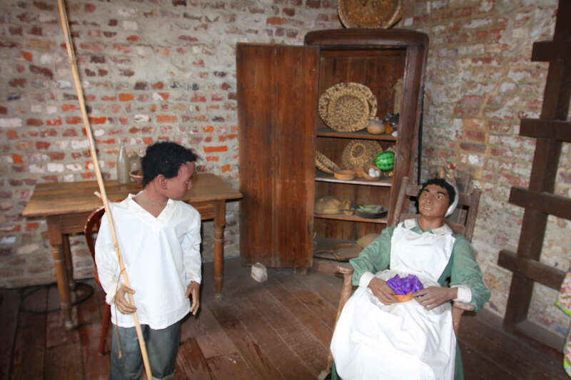 This scene is located inside an original slave cabin on Boone Hall Plantation in South Carolina. The walls in the background are original, and slaves actually lived in this cabin.