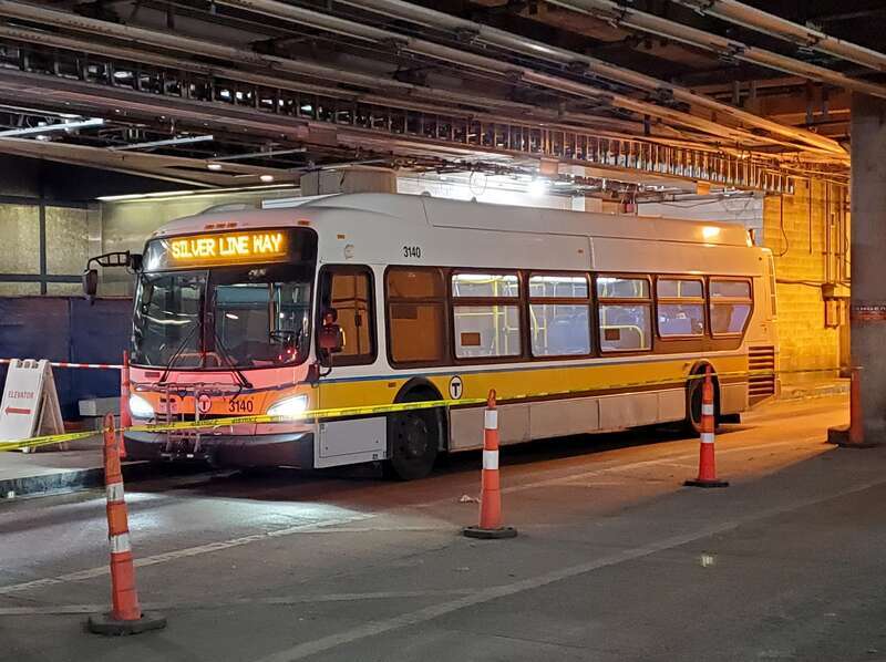 MBTA bus #3140 running outbound as a Silver Line shuttle at Courthouse station in December 2022. Several 40-foot buses were operating some Silver Line service (using battery power in the Waterfront Tunnel) at the time due to a shortage of the aging