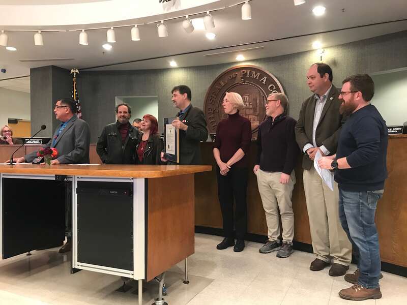 Staff from Tucson Sentinel presented with a plaque proclaiming 22 January 2020 to be “TucsonSentinel.com Day” from the Pima County Board of Supervisors; Left to right, Supervisor Richard Elias, columnist Blake Morlock, music columnist Julie Jennings