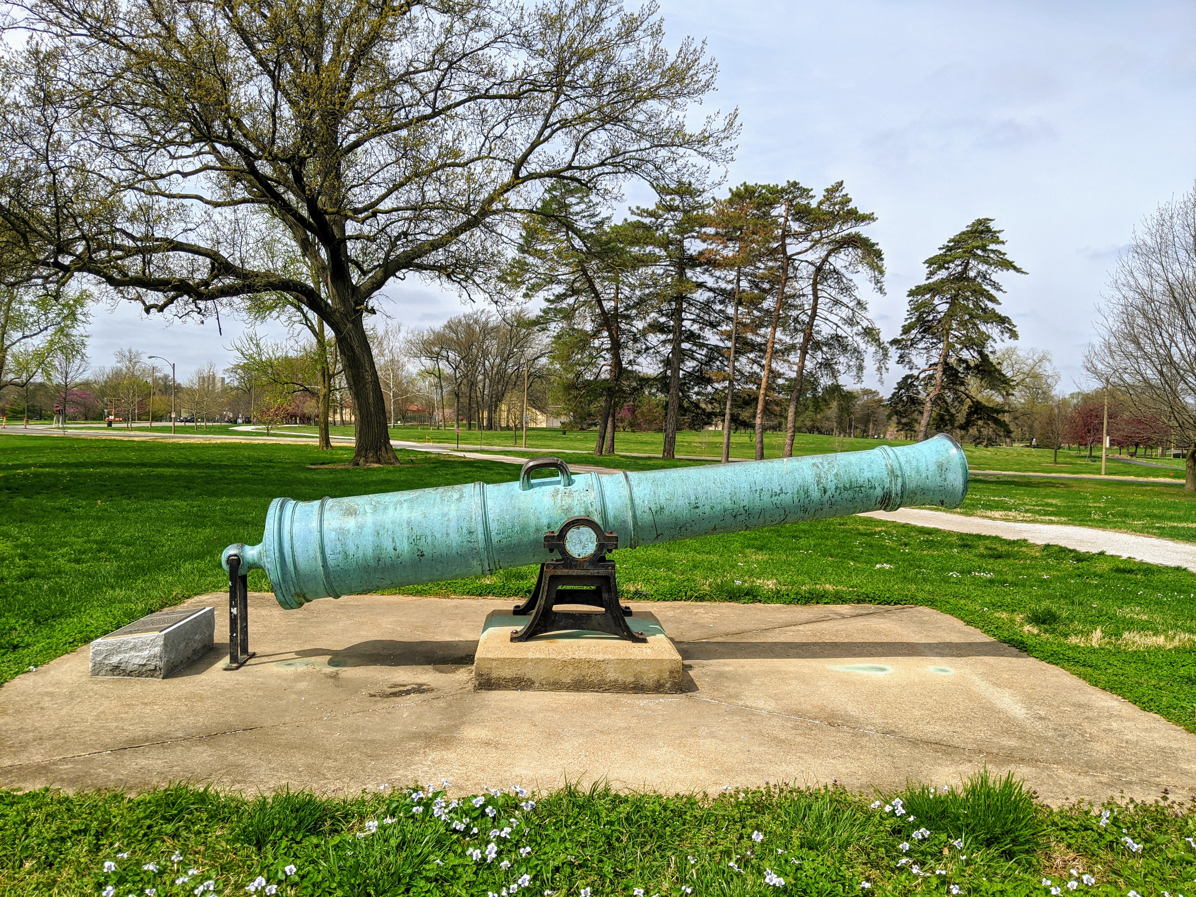 Copper cannon in green patina located in Forest Park. According to plaque, cast at the Royal Artillery Foundry in Seville, Spain on March 21, 1783. Turned over to eh US Army in Santiago, Cuba following the Spanish-American war in 1898. Presented to