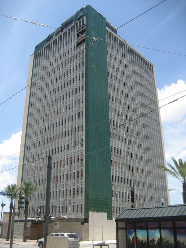 Building at downtown lake corner of Canal Street and Marais Street, New Orleans. Vacant and formerly occupied by Texaco (faded letters can be seen on the green section of the building).