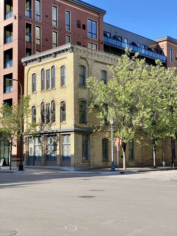 Built between 1882 and 1886, this this buff brick Italianate-style building was formerly known as the Foster House Hotel, a boarding house.  The building features brick pilasters, decorative brickwork below the roofline, a bracketed cornice, arched