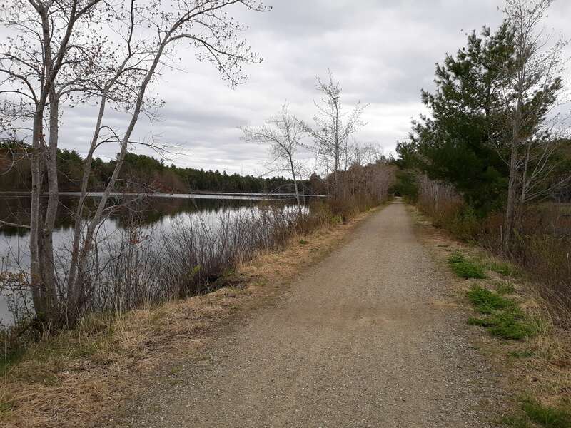 Monadnock Recreational rail trail in Jaffrey, New Hampsire with Contoocook Lake in the background.