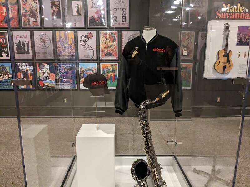 A jacket, hat, and saxophone owned and used by jazz musician James Moody, on display at the Savannah History Museum