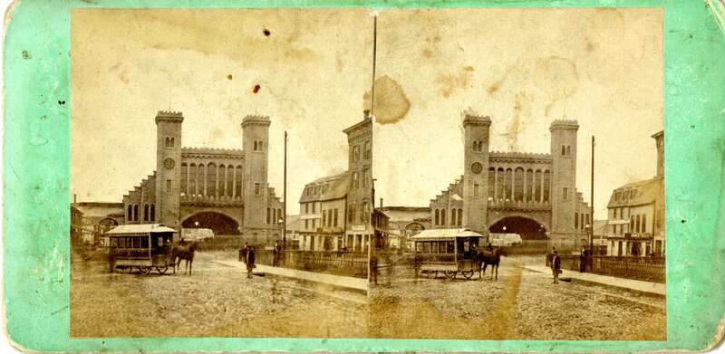 Stereo view looking south at the Eastern Railroad depot in Salem, Massachusetts on Washington Street. People are in view in front of the depot along with a &quot;North &amp;amp; South Salem&quot; horsecar. Circa 1870.