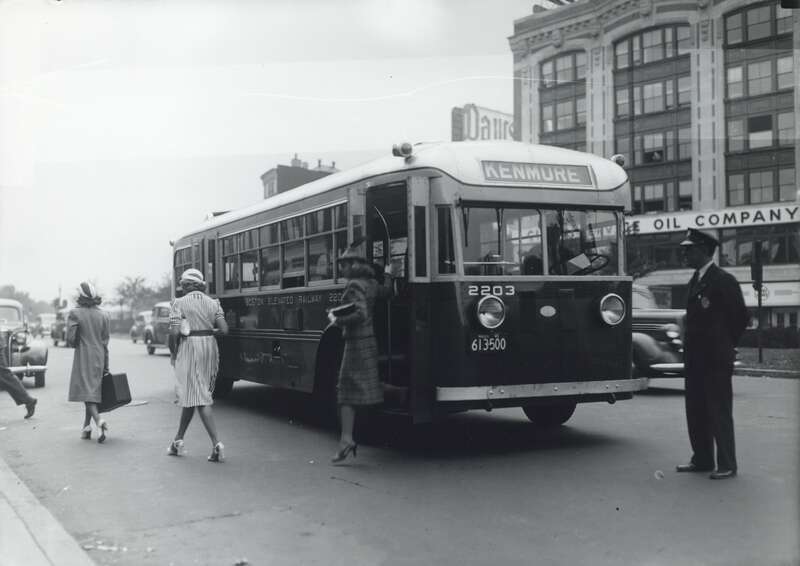 A Boston Elevated Railway bus, likely on the 58 or 60 route, deboards passengers at Kenmore Square in the 1940s. The bus is a Model 40-R(DE) diesel-electric built by Twin Coach in 1937.