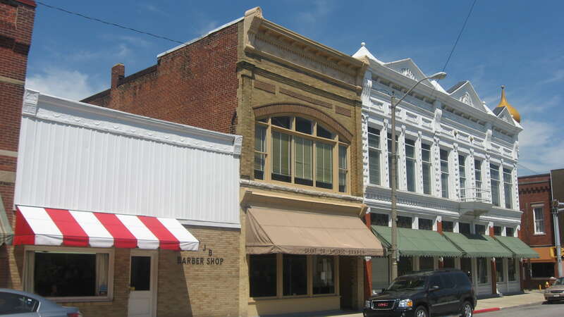 Buildings in the 100 block of S. Main Street in downtown Fairmount, Indiana, United States.  From left to right, they are:
110 S. Main, built 1890
108 S. Main, built 1890
Bogue Block, 102 S. Main, built 1889 in Italianate style
This block is part of