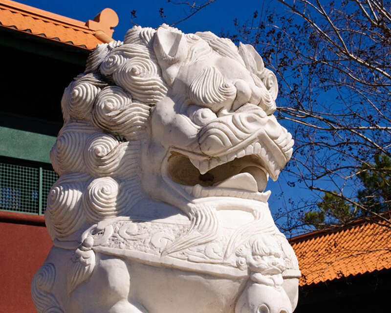 Marble lion guarding the entrance to Forbidden Gardens in Katy, TX