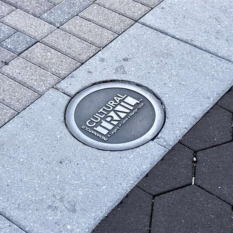 Image of a medallion inset with the logo of the Indianapolis Cultural Trail in Indianapolis, Indiana, United States.