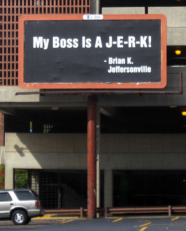An unusually personal billboard, located along the northern edge of the parking lot on the northeastern corner of the junction of Fifth and Chestnut Streets in downtown Louisville, Kentucky, United States.