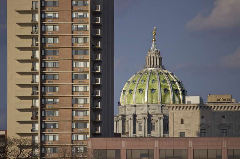 The Capital's dome and Presbyterian Apartments from City Island