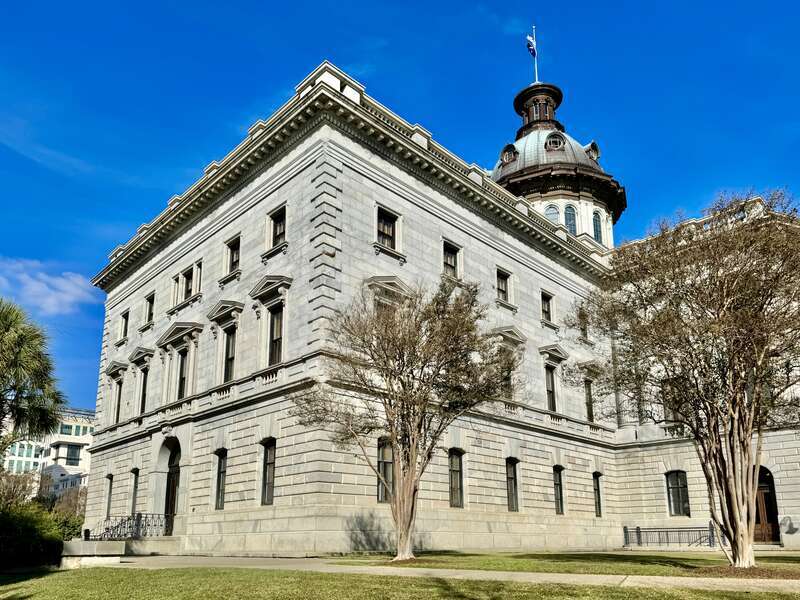 Built in 1851-1907, this Classical Revival-style building was designed by P. H. Hammarskold, John Niernsee, Frank McHenry Niernsee, Frank Pierce Milburn, and Charles Coker Wilson to serve as the state capitol building for South Carolina.  The