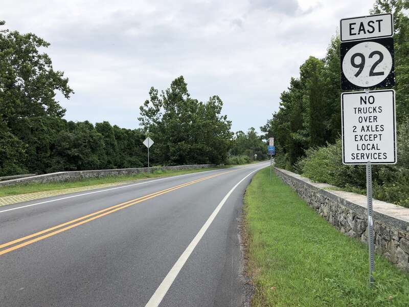 View east along Delaware State Route 92 (Thompsons Bridge Road) at Delaware State Route 100 (Montchanin Road) and East Adams Dam Road in Winterthur, New Castle County, Delaware