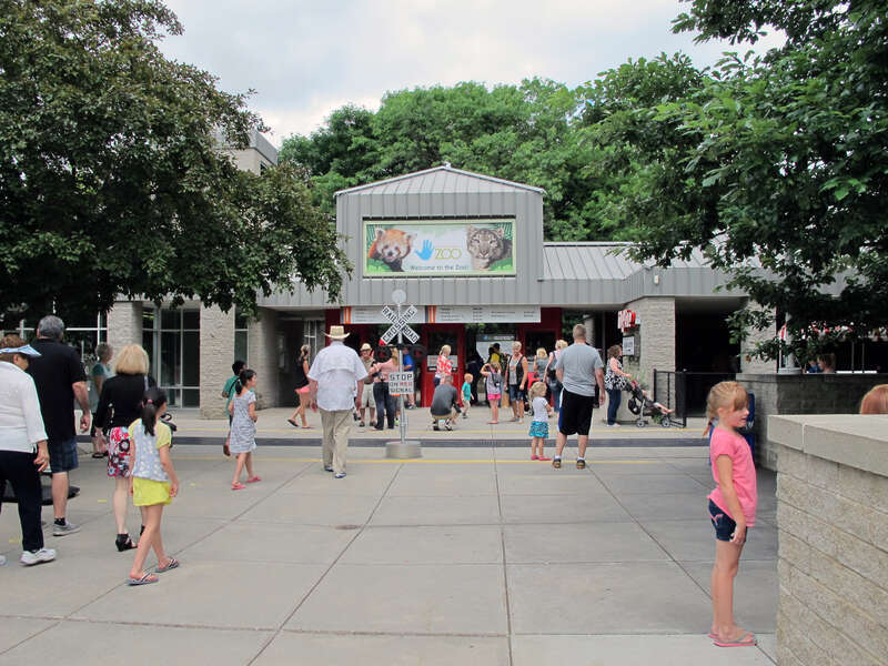 Photo of the entrance to the Lincoln Children's Zoo, 1222 S. 27th Street in Lincoln, Nebraska.  Photo taken facing nearly northeast at the front gates of the zoo.  The ZO&amp;amp;O Train Depot can be partially seen on the right (with the backside of the