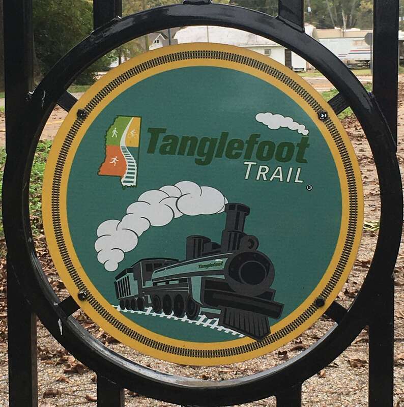Sign featuring the logo of the Tanglefoot Trail