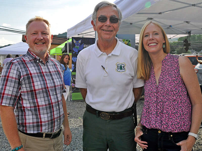 Thomas Minney, State Director of The Nature Conservancy in West Virginia, Forest Supervisor Clyde Thompson, and Darley Newman visited with families enjoying the booths and activities at the Pocahontas County Opera House in Marlinton, West Virginia,