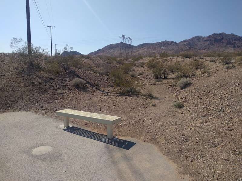 Bench in Bootleg Canyon, &quot;BC&quot; sign on hill in the back.