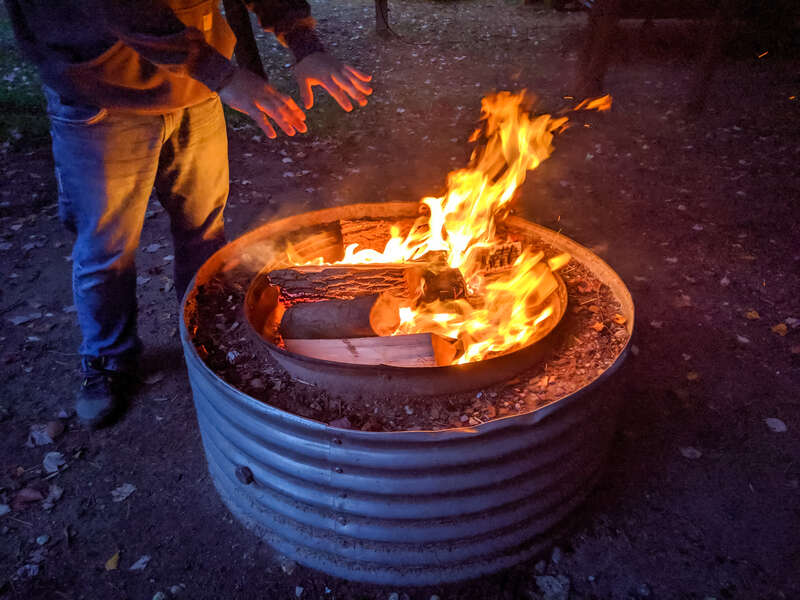 Campfire in a metal fire ring.