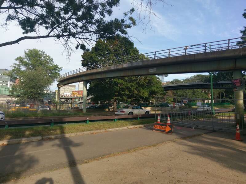 The old pedestrian footbridge over Storrow Drive in Boston during demolition, with the new Frances Appleton Bridge in the background.