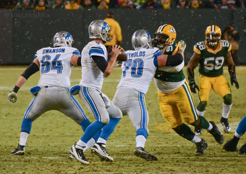 Matthew Stafford about to pass during a 2014 game against the Green Bay Packers