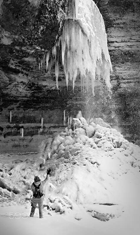 500px provided description: Taken at Munising Falls in the Upper Peninsula of Michigan. Not even the frigid temperatures and 20+ inches of freshly fallen snow stopped this stream. [#Munising Falls ,#Snow ,#Winter ,#Waterfall ,#Michigan ,#Munising