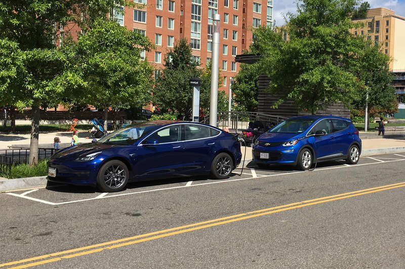 Tesla Model 3 (left) and Chevrolet Bolt EV (right) charging at a ChargePoint on street public charging station. Washington, D.C.