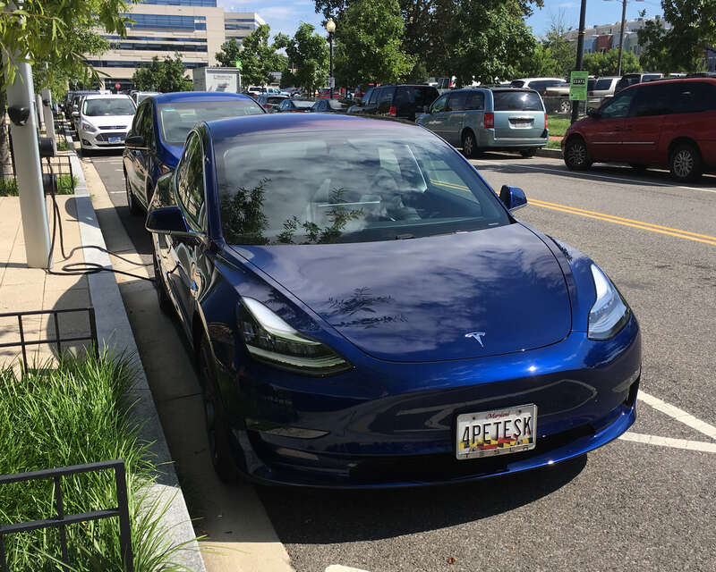 Tesla Model 3 charging at a ChargePoint on street public charging station. Washington, D.C.