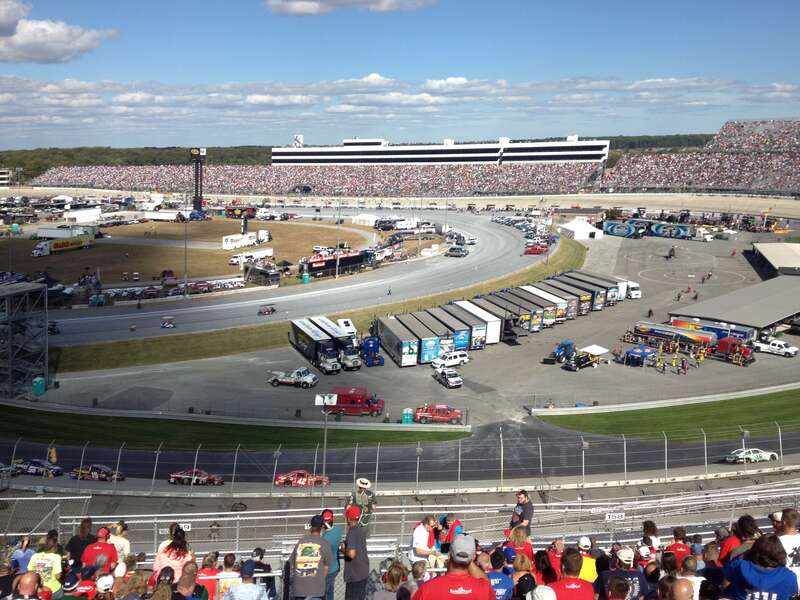 The 2013 AAA 400 at Dover International Speedway viewed from turn 3. Kyle Busch (#18) leads Juan Pablo Montoya (#42), Jamie McMurray (#1), Clint Bowyer (#15), and Martin Truex, Jr. (#56) following the first caution due to debris.