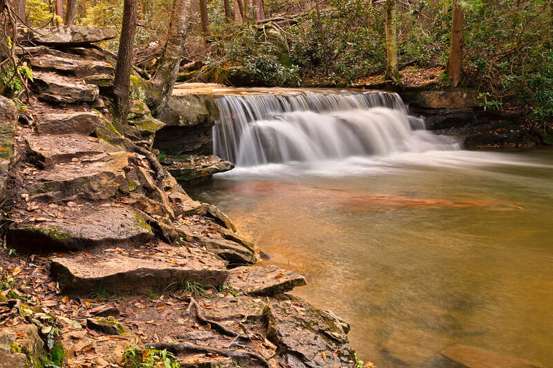 Long exposure waterfall from Swallow Falls State Park in Maryland, USA. HDR composite from multiple exposures. 
For those who might want to use this photo for editorial purposes, please note the waterfall &amp;amp; stepping stones face the opposite