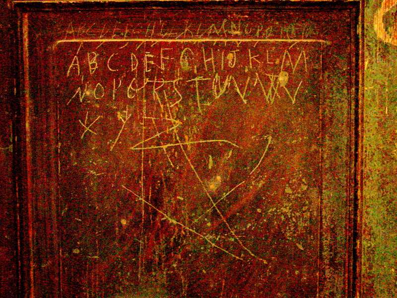 Letters of alphabet incised inside wardrobe door at Belle Mont historic house in Alabama. (Retouched to reduce glare.)