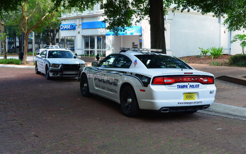 Two Tampa Police Dodge Chargers each other with front views. (Florida, USA).