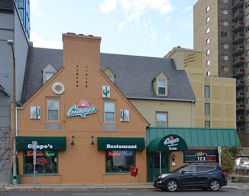 A small building housing Guapo's Restaurant, featuring Fine Tex Mex. 8130 Wisconsin Ave, Bethesda, Maryland 20814.