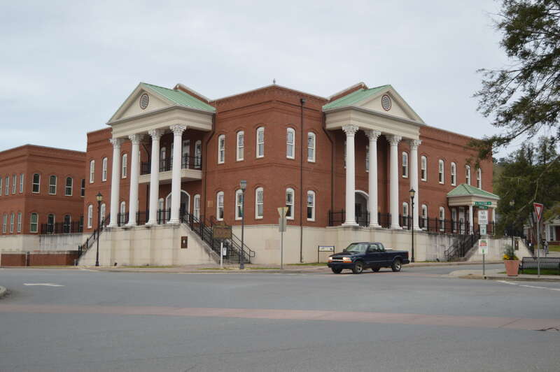 Northeastern and southeastern facades of the Gilmer County Courthouse, located on the western side of Courthouse Square in Ellijay, Georgia, United States.  Built in 2008, it sits on the site of a previous courthouse that was listed on the National