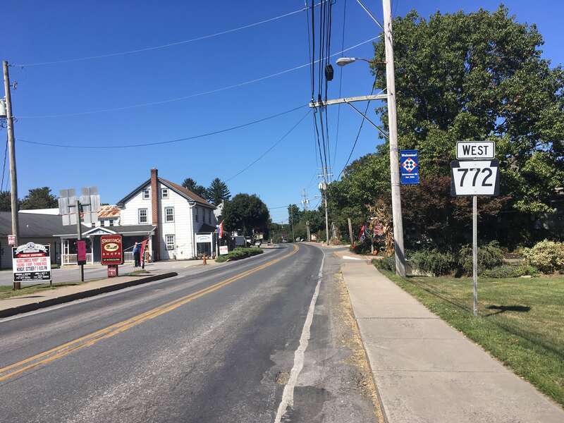 Westbound Pennsylvania Route 772 (Newport Road) past the intersection with Pennsylvania Route 340 (Old Philadelphia Pike/Main Street) in Intercourse, Pennsylvania