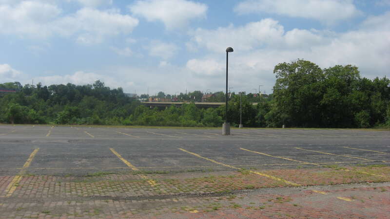 Empty land in southern downtown Youngstown, Ohio, United States, looking from the foot of Champion Street toward the dimly visible Market Street bridge.  This was formerly the site of the the Republic Iron and Steel Office Building, a Republic Steel