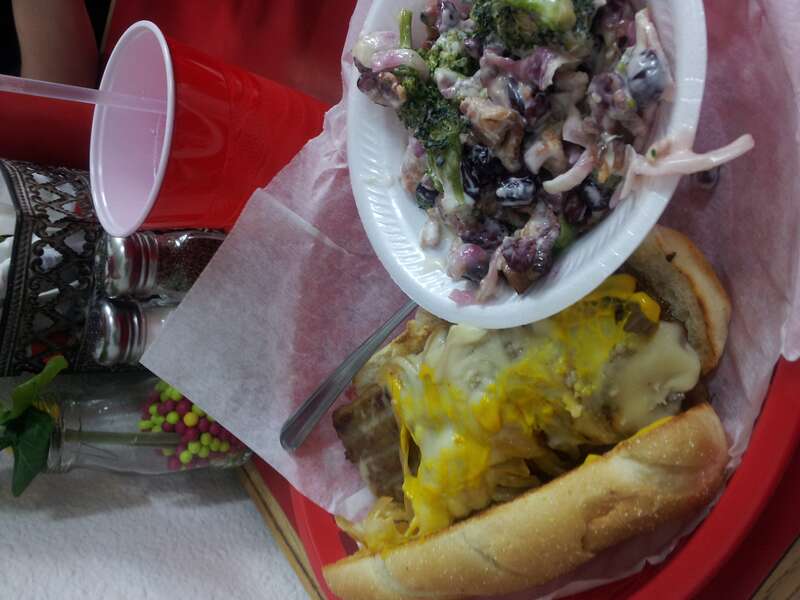 Interesting sandwich - caribou steak with swiss cheese, mustard and onions on a bun - accompanied by broccoli and cranberry salad.