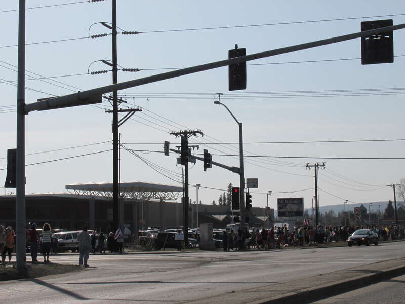 View of the crowds which gathered along Airport Way in Fairbanks, Alaska (University Avenue intersection shown) during the funeral procession conducted by Alaska State Troopers.  They were bringing the bodies of troopers Gabriel Rich and Scott