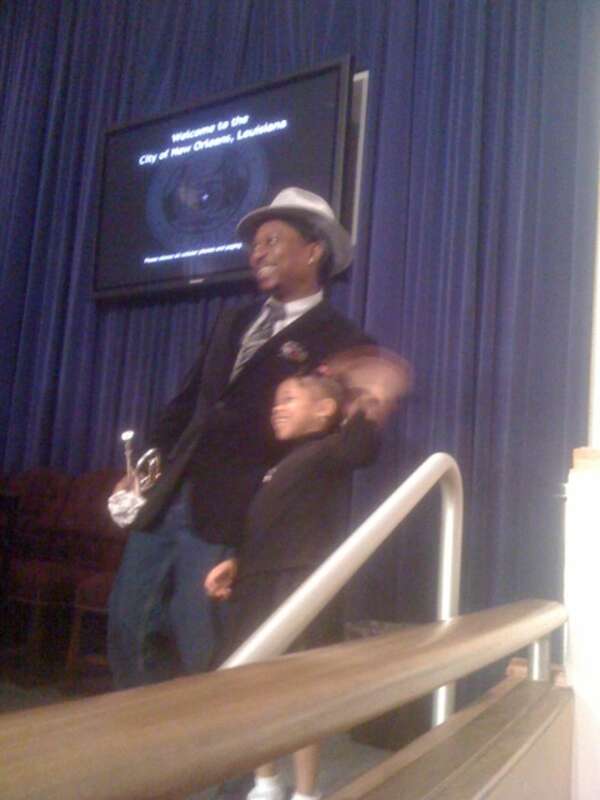 Musician Kermit Ruffins and child at New Orleans City Council Chambers