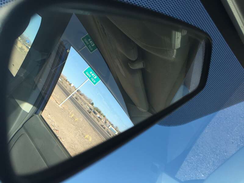 Entering &quot;Elko, 5060&quot; feet above sea level sign reflected in a rear-view mirror on Idaho Street (Nevada State Route 535 and Interstate 80 Business) in Elko, Nevada