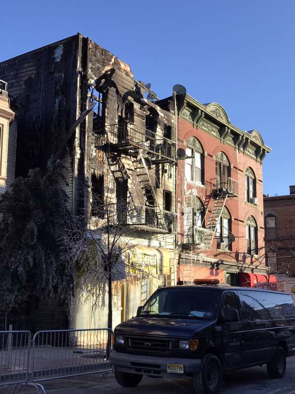 Looking south on Summit Avenue between 15th and 14th Streets in Union City, the afternoon of March 4, 2017. The yellow building is the burnt-out remains of 1404 Summit Avenue, where a fire began around 1:00am EST, before spreading to SS. Joseph and