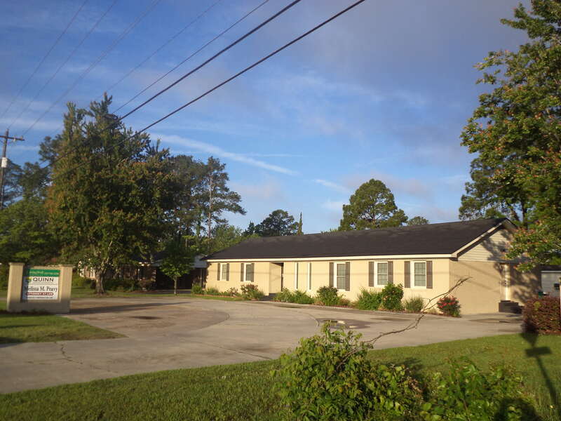 According to the sign, in this building are Living Well Properties, Quinn Construction and Melissa M. Peavy Attorney at Law, 3316 Bemiss Rd, Valdosta, Lowndes County, Georgia