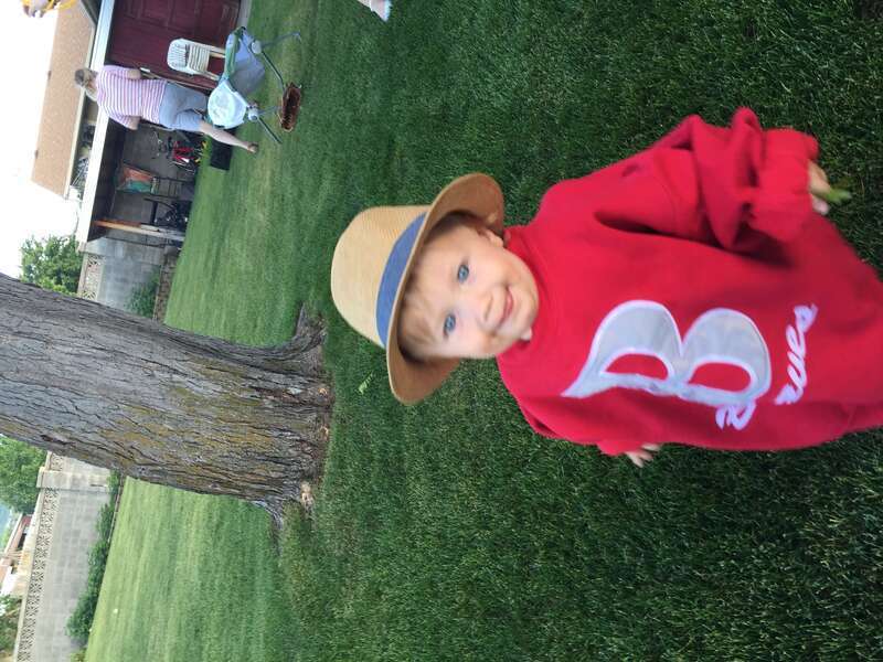 A young boy playing around in his grandmother's backyard