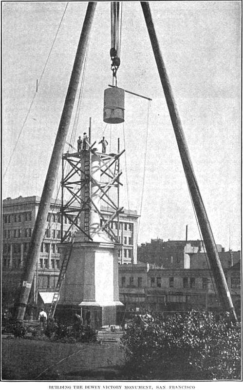 Workers lift a 20-ton block of granite during assembly of the Dewey Monument in San Francisco's Union Square in late 1902.