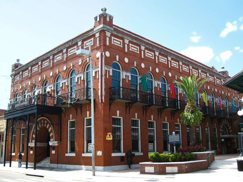 El Centro Español de Tampa, a U.S. National Historic Landmark in the Ybor City Historic District of Tampa, Florida.  Iron balconies wrap around the east facade to the south facade along 7th Avenue, where they are joined by an iron canopy framing the