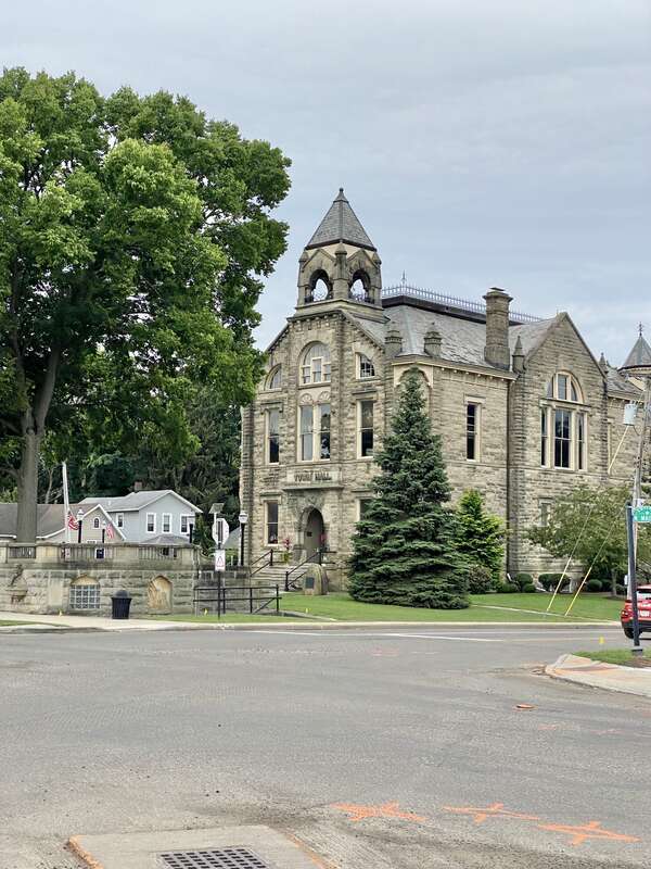 Built in 1884, this Queen Anne-style rusticated Amherst sandstone building was constructed to house the municipal government and municipal services for the city of Amherst.  The building sits on the Amherst town square in Downtown Amherst, with a