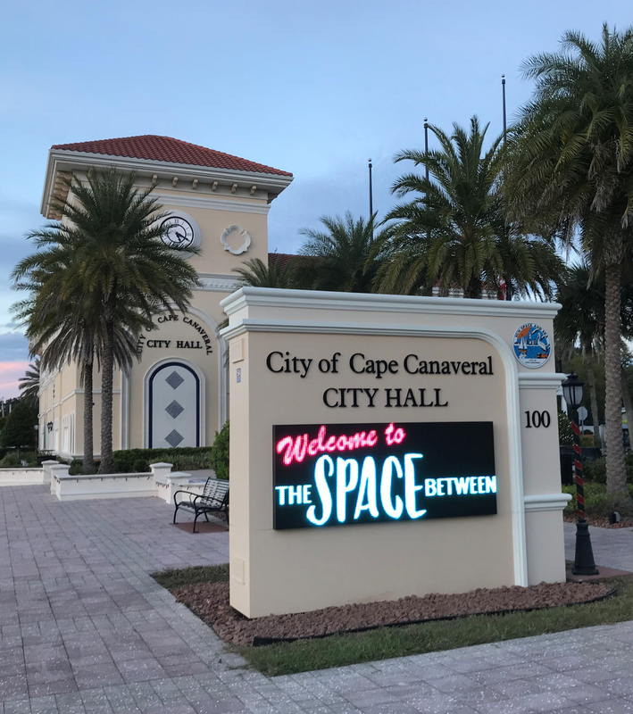 Photo taken at dusk of the City of Cape Canaveral's City Hall with the electronic marquee sign in the foreground.